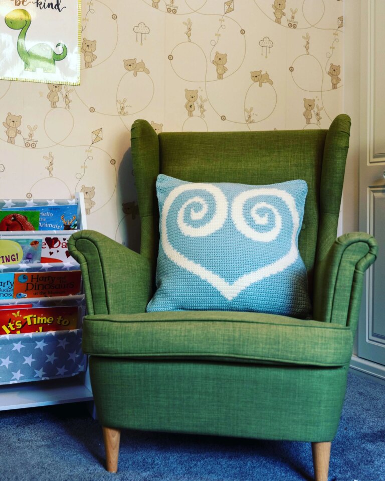 Green armchair heart cushion nursery