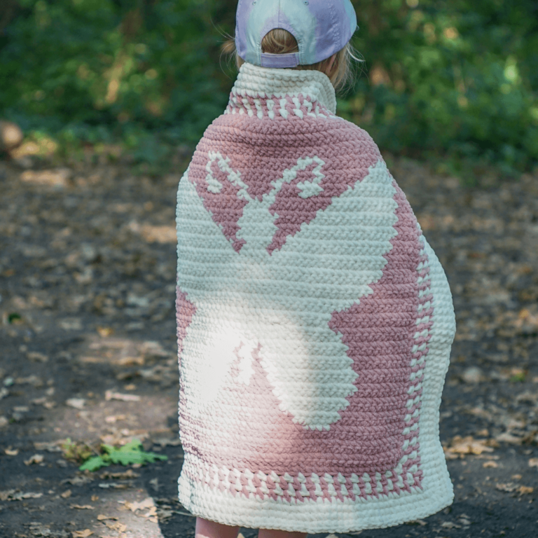 Child in butterfly crochet blanket
