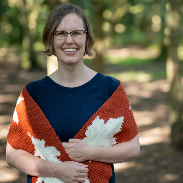 Smiling woman handmade crochet shawl