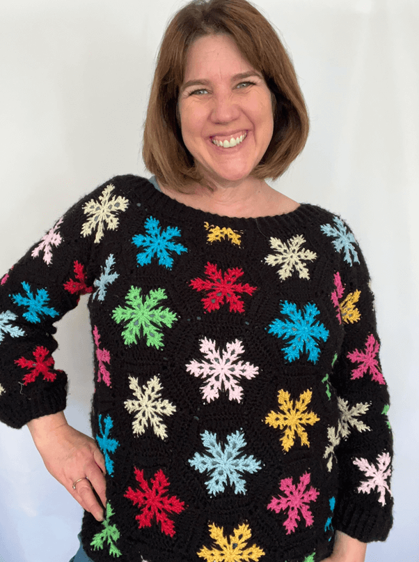 Woman wearing crochet snowflake sweater