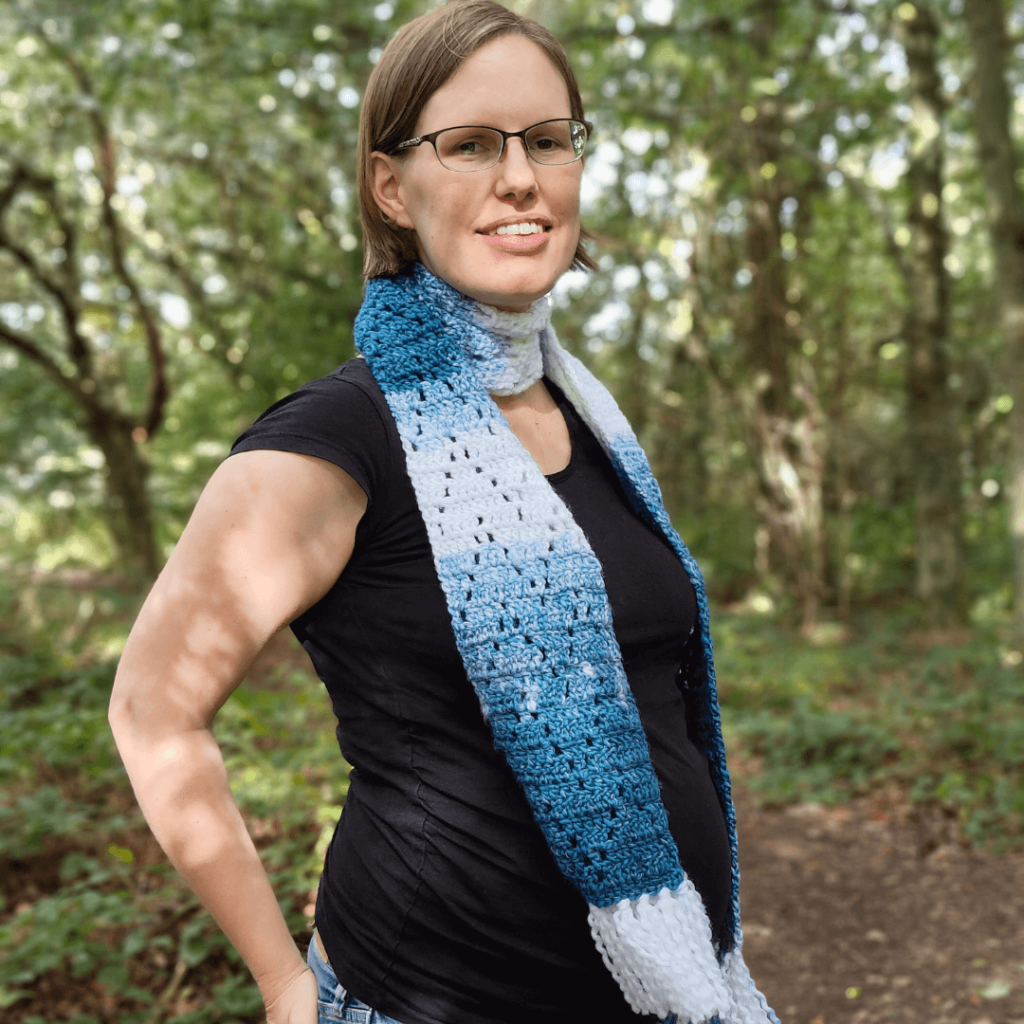 Woman wearing blue crochet scarf