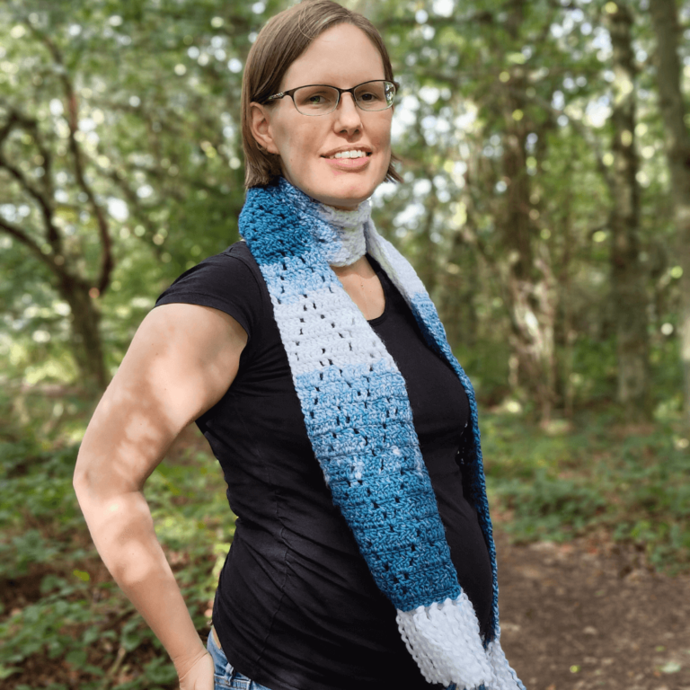 Woman wearing blue crochet scarf