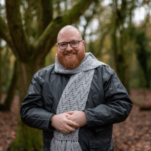 Smiling man grey scarf