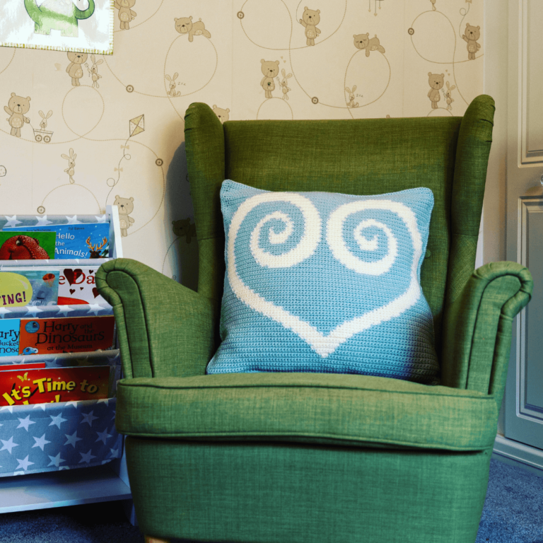 Green armchair crochet heart pillow