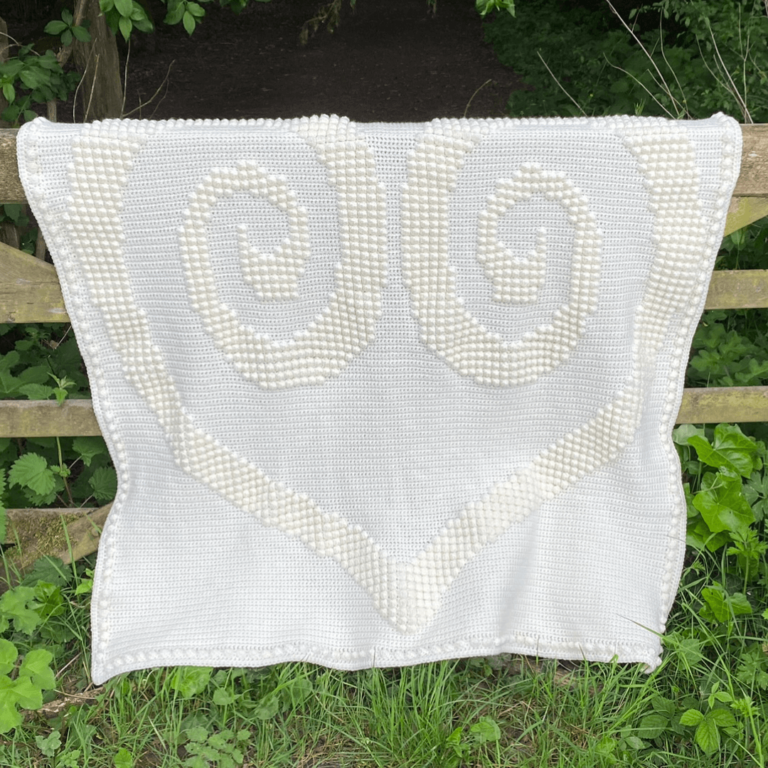 White crochet heart blanket