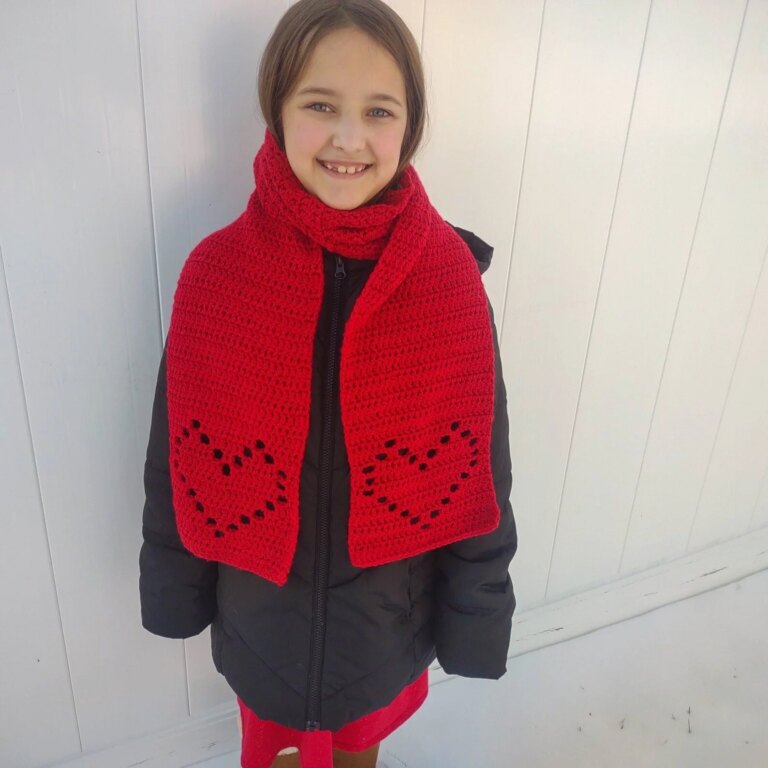 Smiling girl red heart scarf