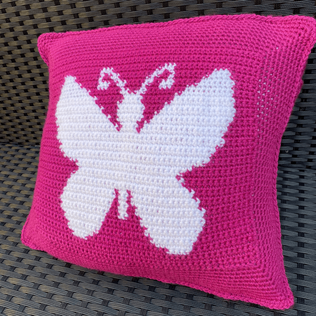 Pink crochet butterfly pillow