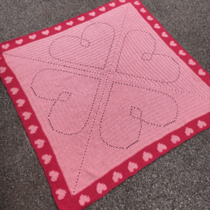 Pink crocheted heart blanket