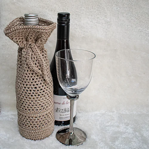 Crocheted wine bottle, glass.