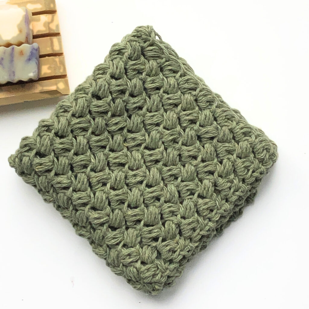 Green knitted scrubber, soap bars