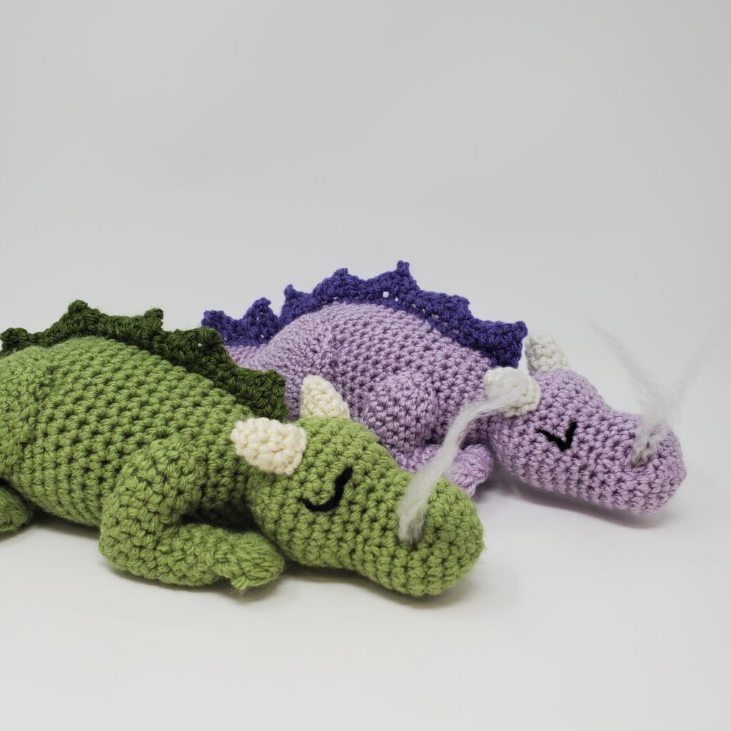 Crocheted green and purple dragons