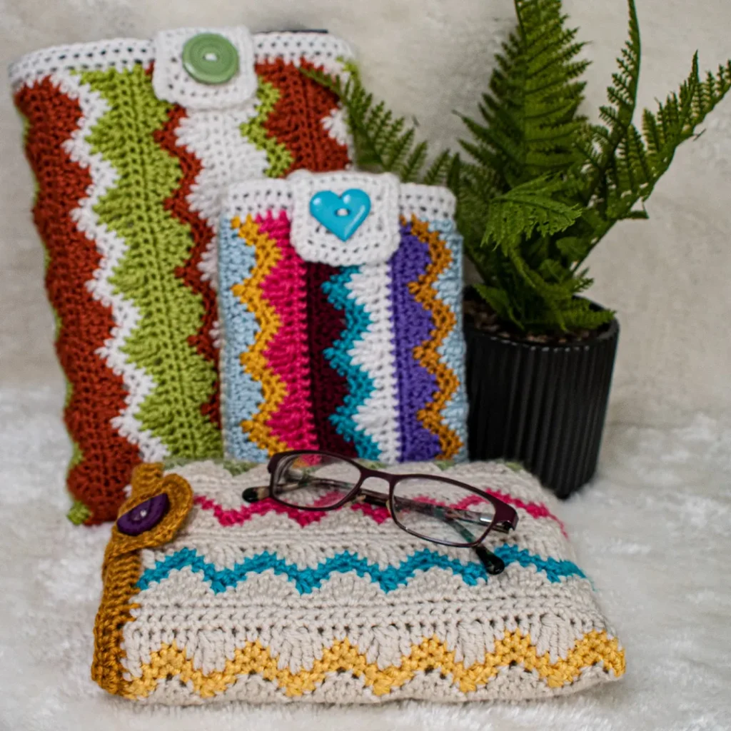 Colorful crochet pouches, eyeglasses, plant