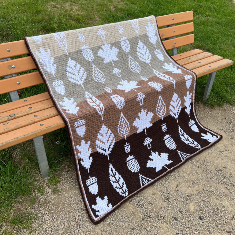 Autumn crochet blanket on bench