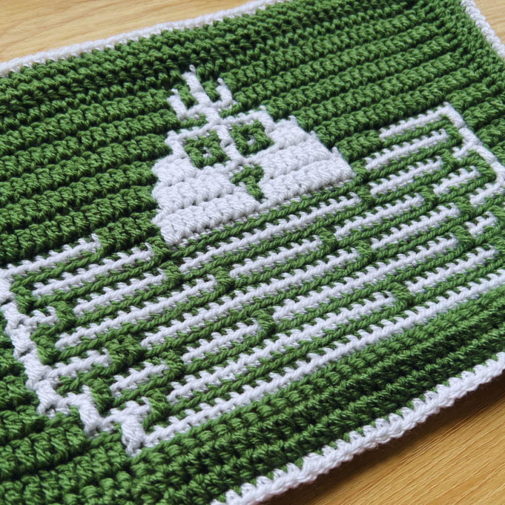 Green and white crocheted building