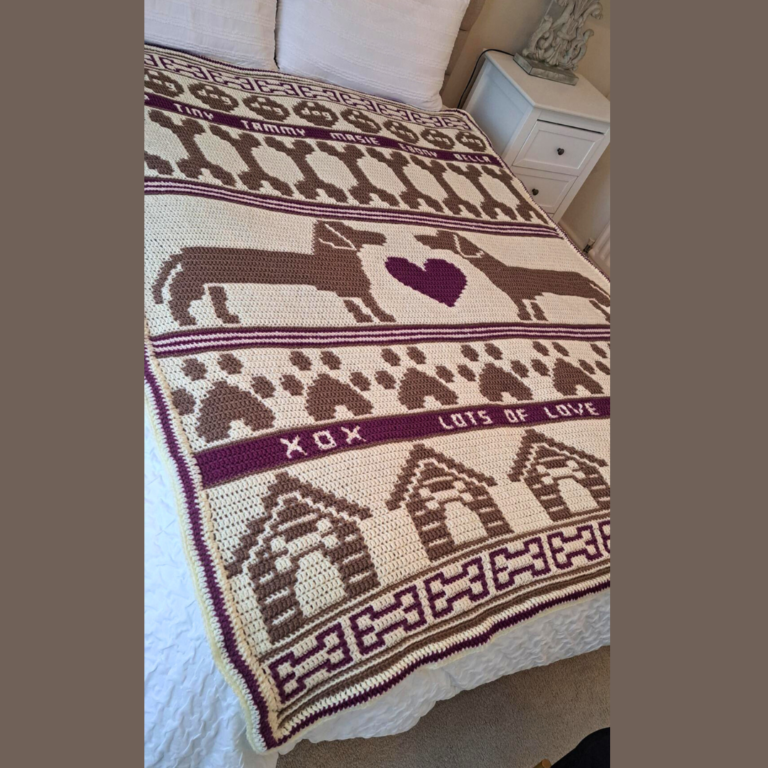 Crocheted dog-themed blanket on bed
