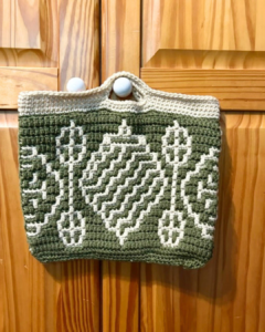 Green crochet bag on wood