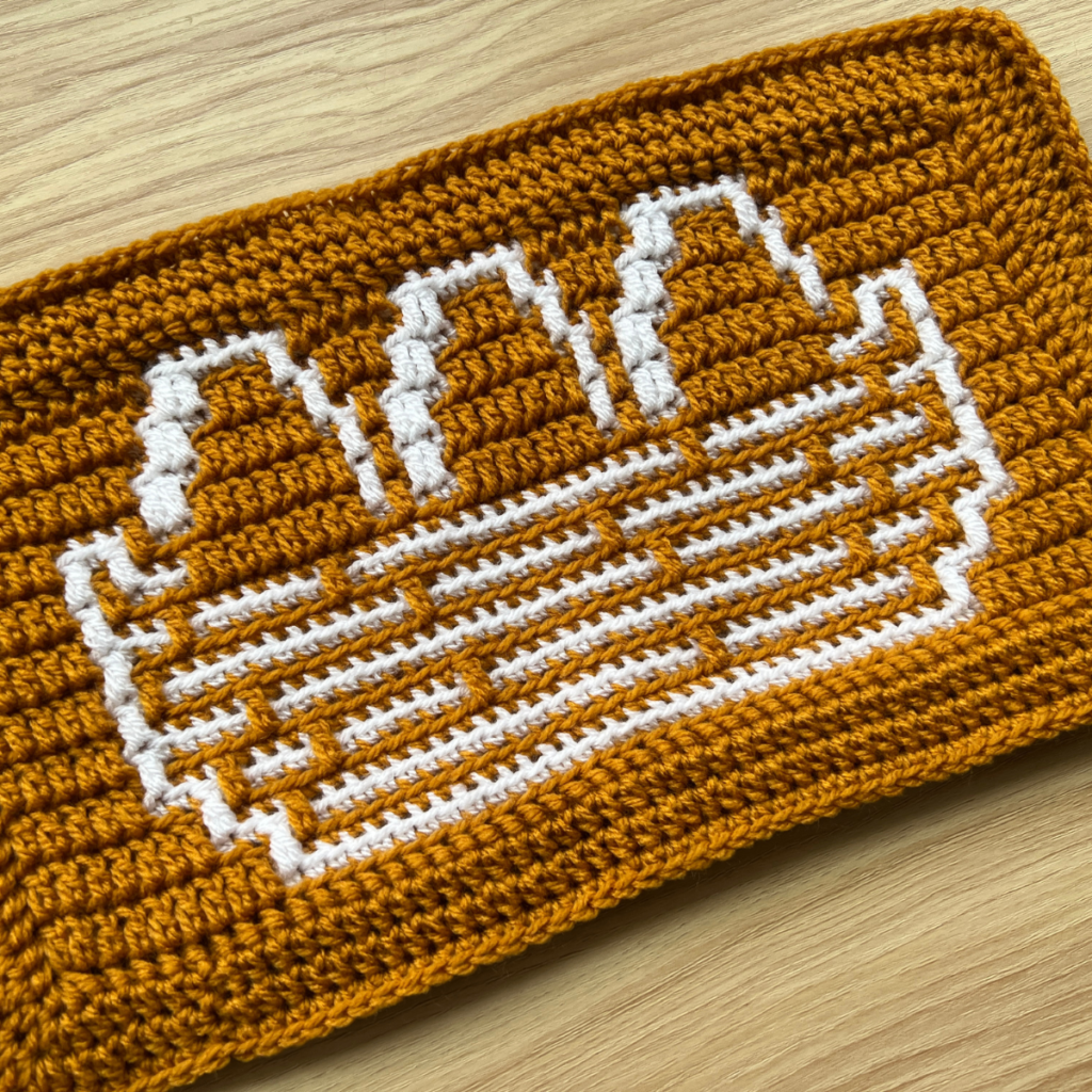Crochet pixelated art of eggs in a nest