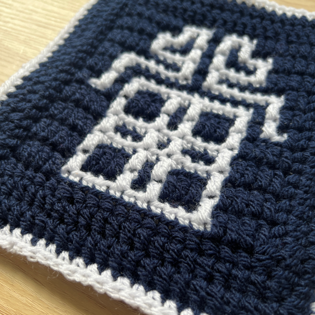 Mosaic crochet coaster in navy white pattern